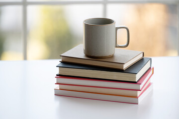 Coffee mug on stack of books