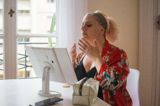 Curvy woman applying foundation
