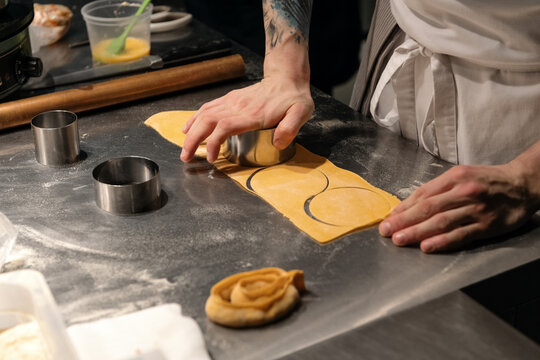 Crop cook cutting pasta dough