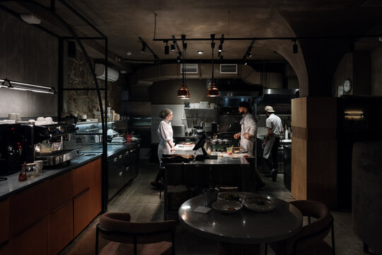 Dim kitchen of modern restaurant during workday