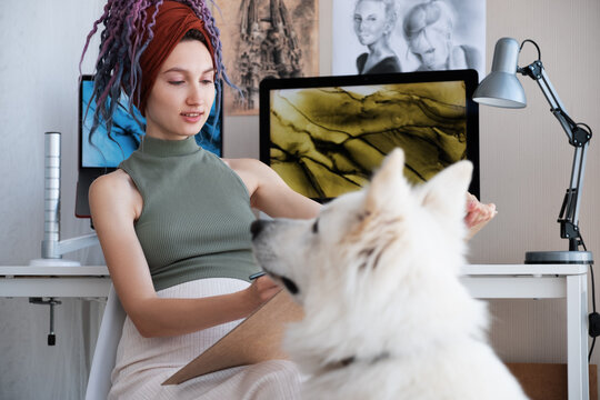 Woman drawing dog in home office