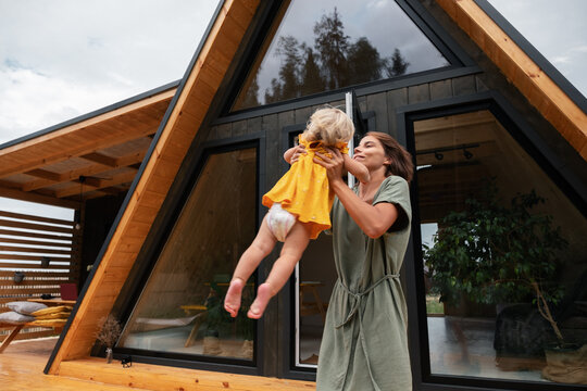Mother playing with daughter on terrace