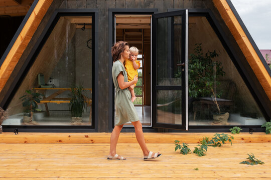 Mother with baby walking on porch