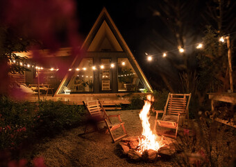 Yard of triangle countryside cottage at night