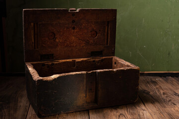 Old wooden box. Vintage wooden box. Chest of green color on a green background.
