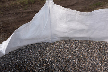 small gravel in a white woven sack