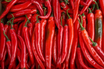 Fotobehang red hot chili peppers  for texture background. sale of spices in the local market. © Andrii