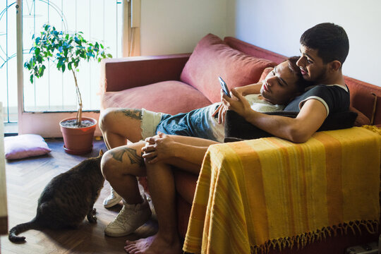 Gay couple with cat at home