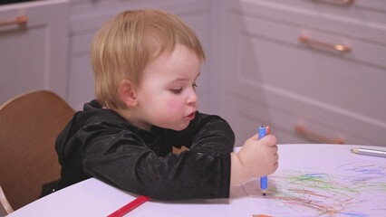 Adorable Caucasian Toddler Baby Girl Drawing Abstract Shapes Picture With Pencil Crayons Making Funny Faces