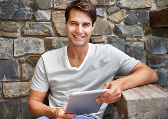 Portrait of a young man smiling at the camera while holding his digital tablet outdoorsCropped shot of a man using his digital tablet while sitting on the deck
