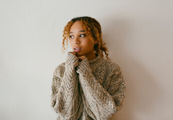 Teenage inside a big wool sweater