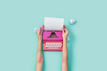 Woman writing on retro typewriter