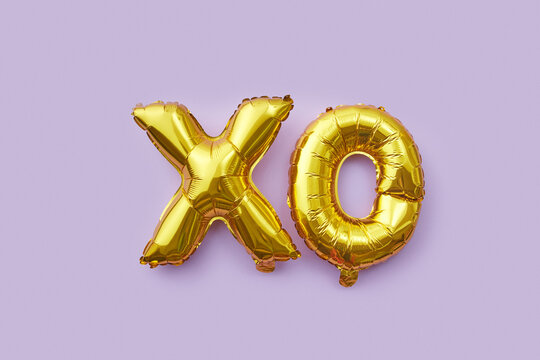 XO shaped golden balloons