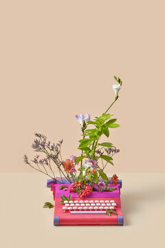 Retro styled typewriter with fresh spring flowers