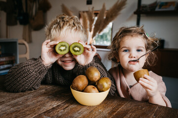 Two kids enjoying fruit