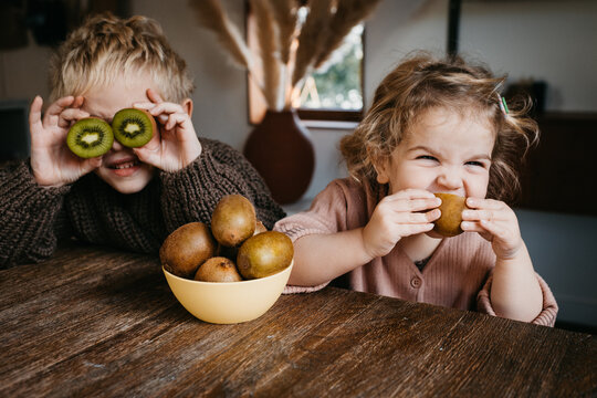 Two kids enjoying fruit