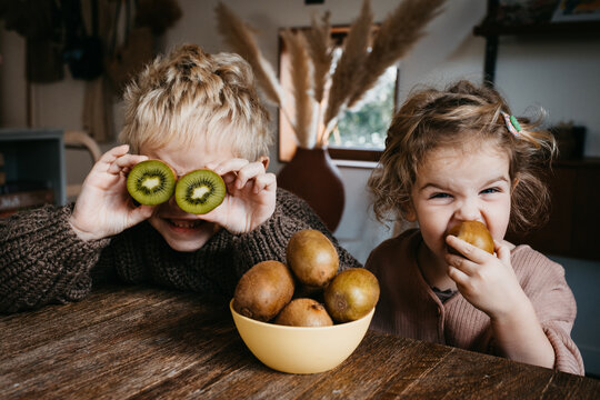 Two kids enjoying fruit