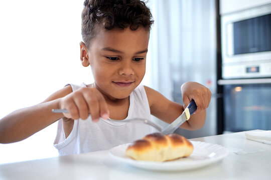 An African American kid eats homemade food