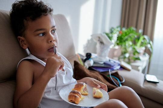 An African American kid eats homemade food