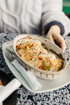 Naklejki female hands holding lasagna