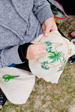 Woman's hands doing cross-stitching
