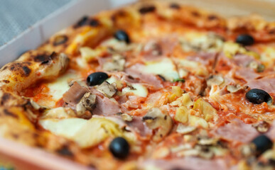 Pizza capricciosa. Pizza with ham, olives, mushrooms and artichokes.
