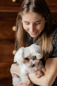 Happy Woman Holding Cute White Dog 