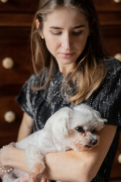 Woman Holding Cute White Dog 