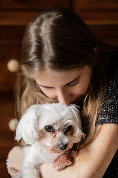 Woman Petting Cute White Dog 