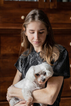 Woman Holding Cute White Dog 