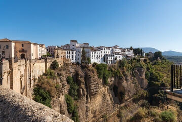 Fototapeta na wymiar Scenic view of the famous white village of Ronda located on El Tajo gorge at daylight, Malaga province, Andalusia, Spain