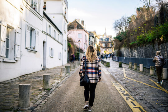 Unrecognizable woman walking on street