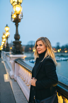 Female tourist enjoying evening on embankment
