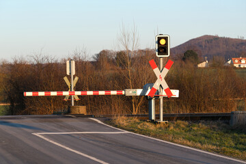 Closed railroad crossing at sunset, traffic and transportation infrastructure.