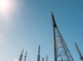 Telecommunications TV and Radio antennas with blue sky. Wireless data transmission technology station