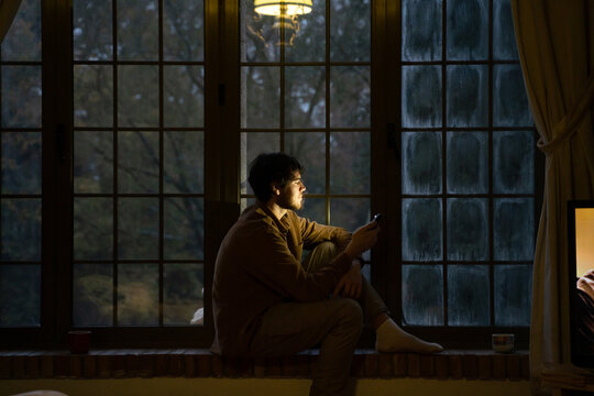 Man using phome at home at night 