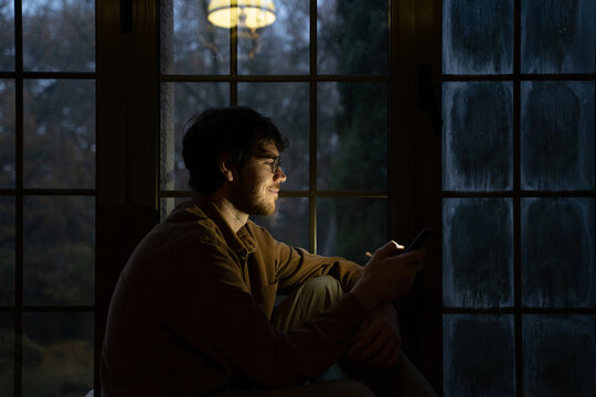 Man using phome at home at night 