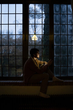 Man using phome at home at night 