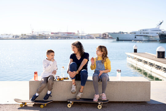 Family having snacks on promenade in summer