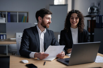 Female worker listening colleague and feeling happy 