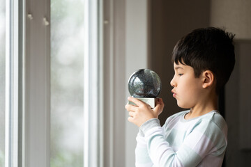 Child holding up snow globe