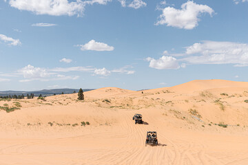 All-terrain vehicles driving in sand dunes