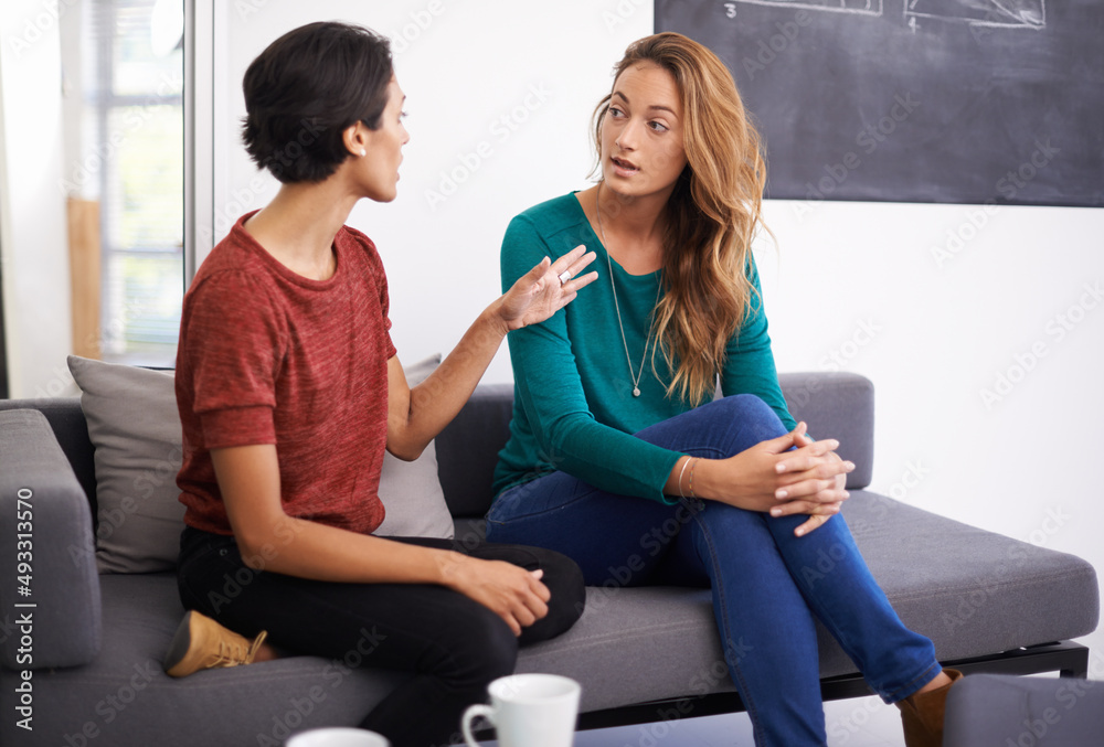 Poster theyre working together on an exciting project. shot of two female professionals having a discussion