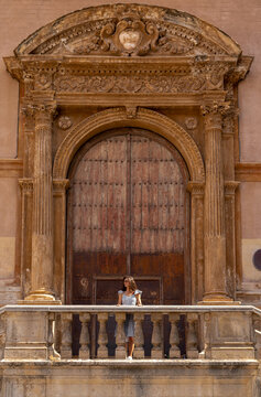 Woman standing in front of a huge gate