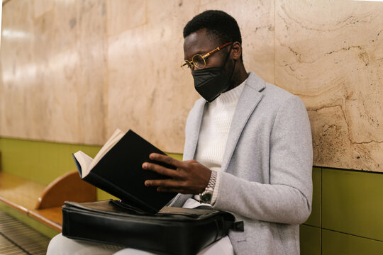 Black businessman with notebook in subway