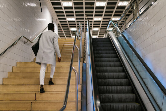 Male walking up stairs in metro station