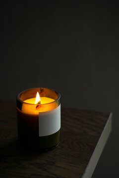 Burning natural candle with a wooden wick