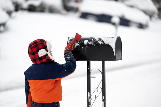 Little kid raising flag on mailbox