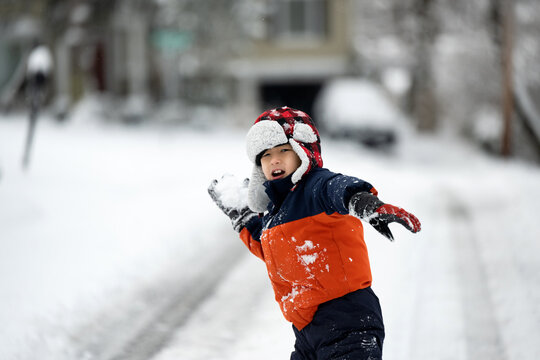 Little kid about to throw a snowball