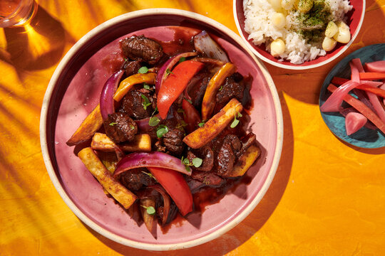 Lomo Saltado, Wok-fried beef tenders, papas fritas, onions, tomatoes, rice